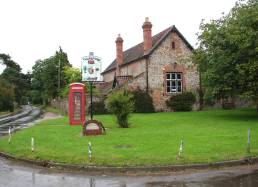 Village green, village sign and village hall in rural England